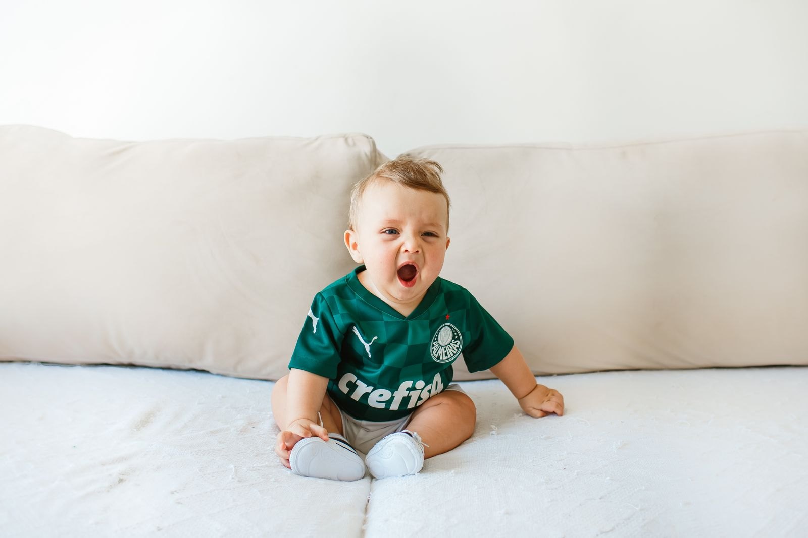 Gähnendes Baby auf einer Decke, kurz vor dem Einschlafen