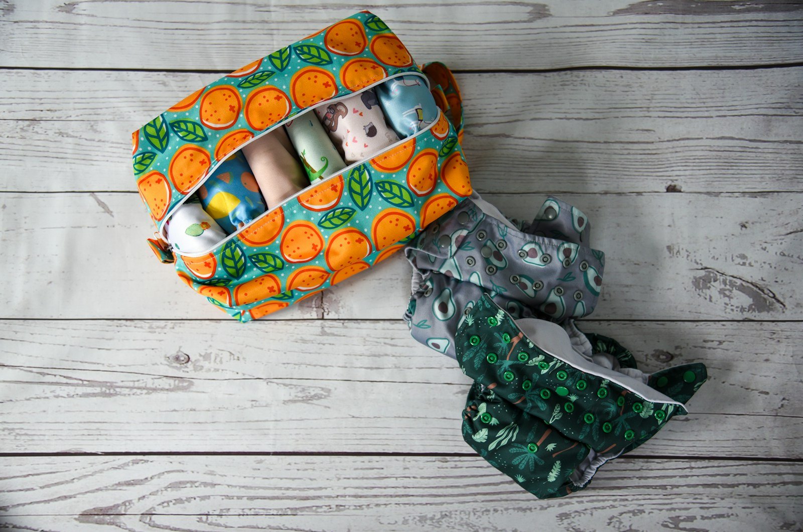 A parent organizing diapers, wipes, and feeding supplies into a diaper bag