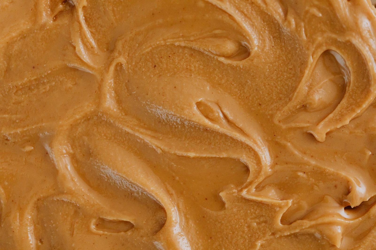 Smooth peanut butter thinned and mixed into infant cereal, an infant-safe way to introduce peanut protein