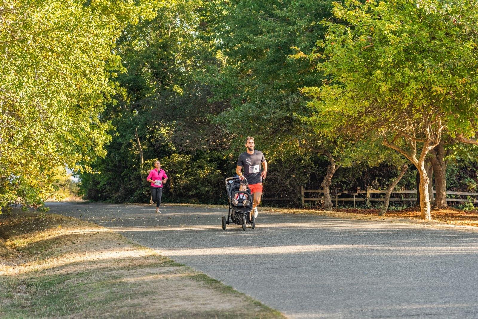 A jogging stroller being used on an outdoor path