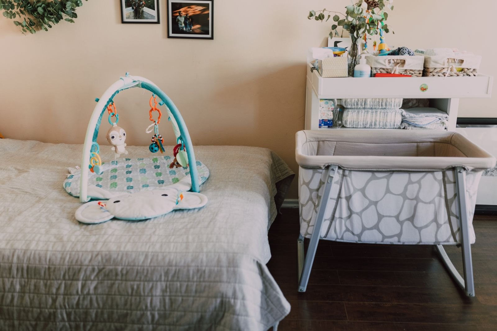 A bassinet positioned beside a parents' bed for room-sharing without bed-sharing
