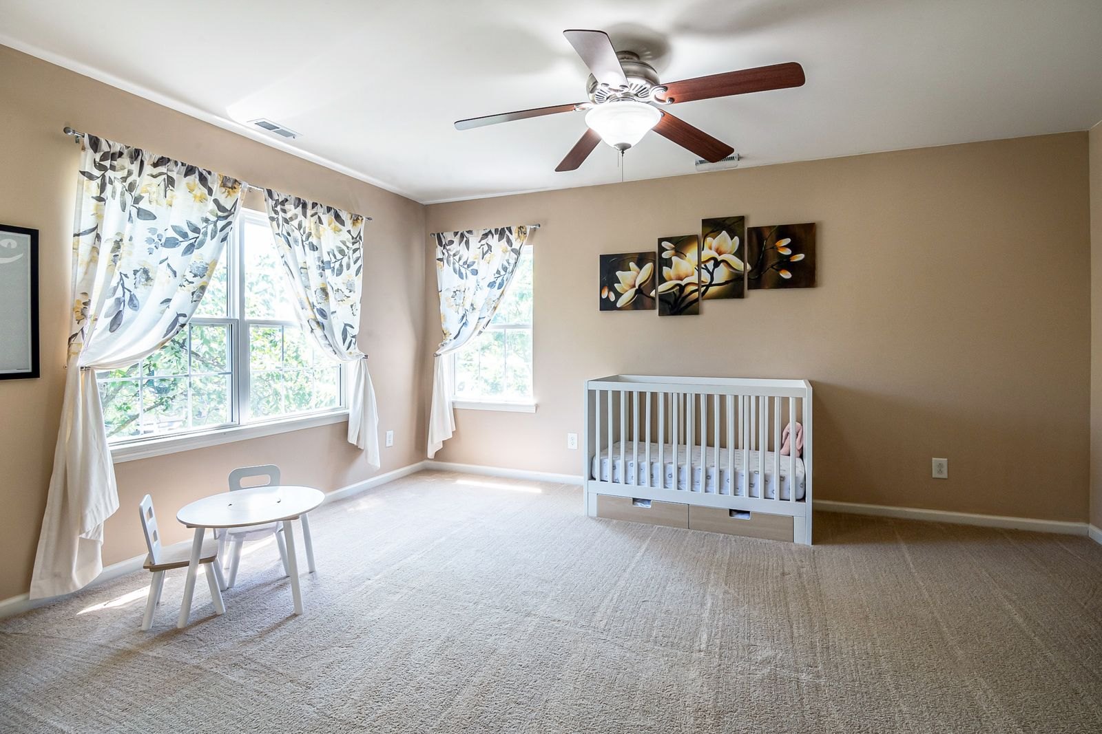 A bright nursery with a crib and sunlight streaming through the window