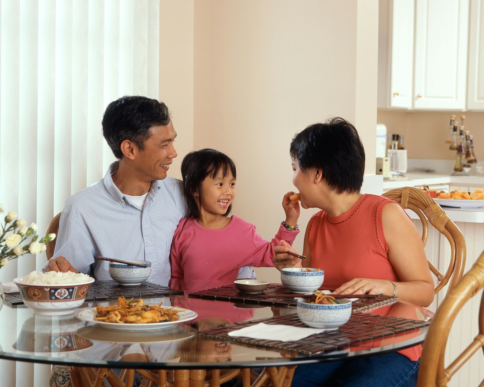 A toddler eating a small variety of foods at a family meal