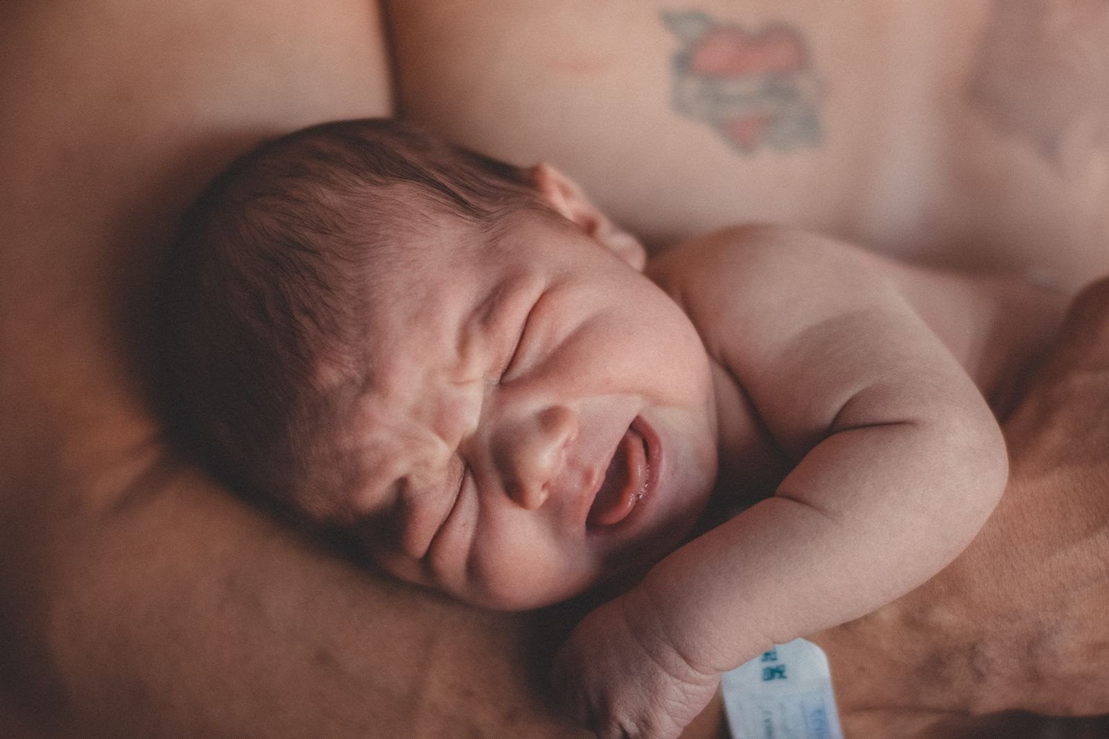 A newborn crying in the evening, a pattern common in the first few months