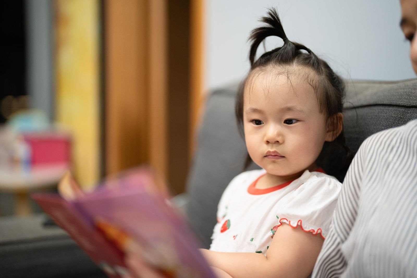 読み聞かせをしてもらう幼児