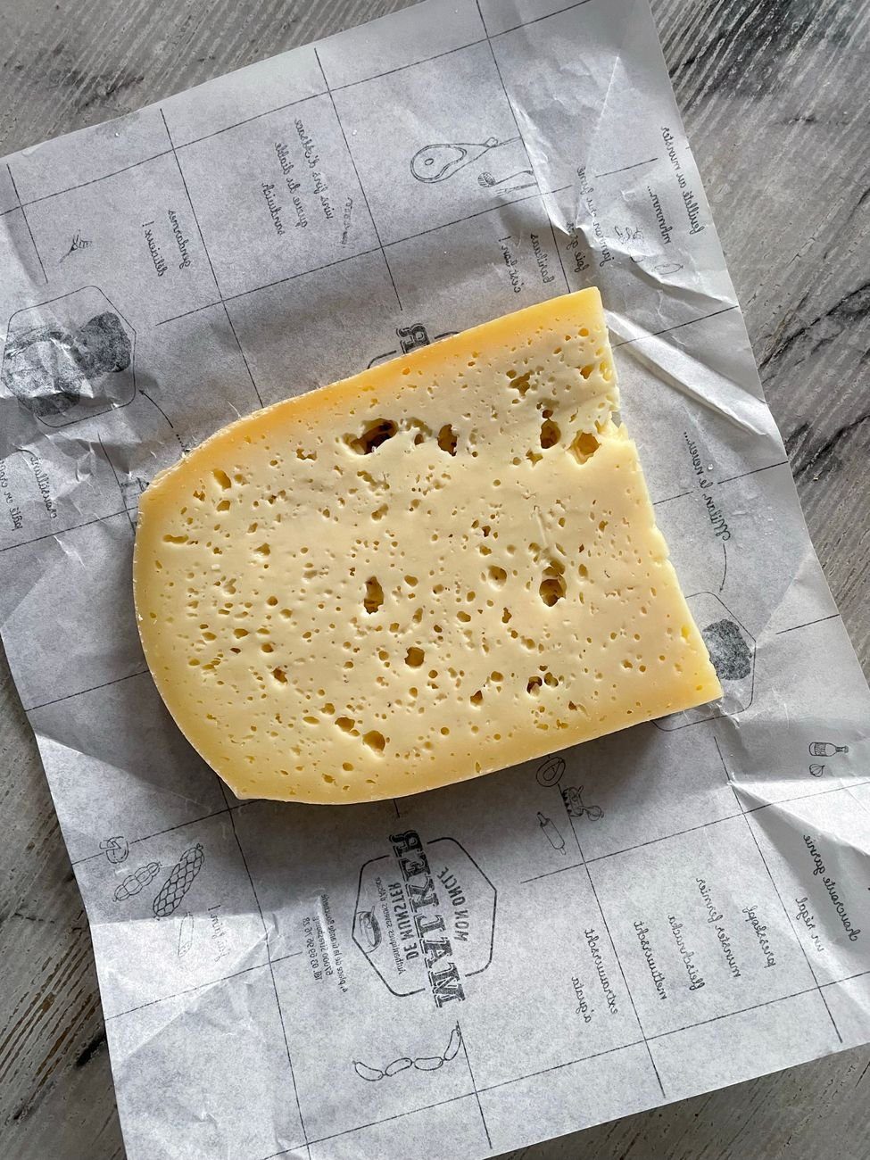 A wedge of cheese, a dairy food whose proteins can produce sulfur compounds when broken down by oral bacteria