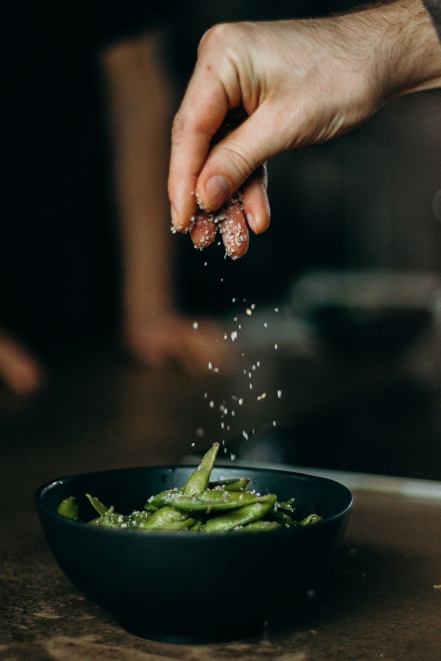 Coarse salt in a bowl, illustrating how dietary sodium drives fluid retention in the body