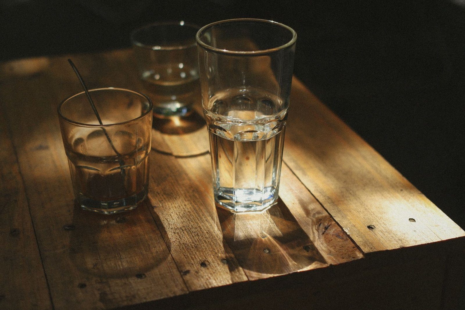 A glass of water on a desk, a reminder of the mild dehydration many adults reach without noticing